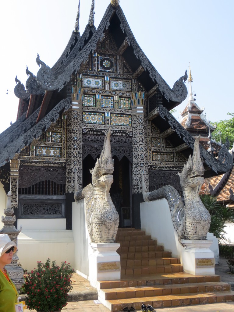 Protective serpents (naga) guard a Buddhist shrine in an old city Chiang Mai temple complex.